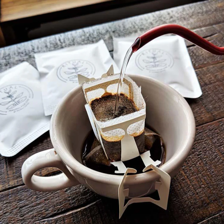 Bags of freshly roasted coffee and a pour-over setup